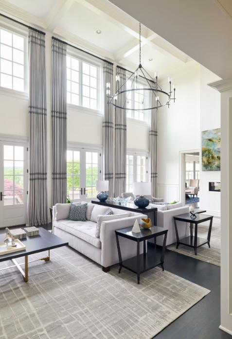 Sophisticated two-story great room with layered textures, bespoke furniture, and luxury design elements tailored to client style.