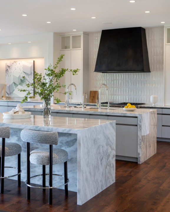 Custom kitchen island in marble with textured stools, showcasing personalized design details and high-end finishes.