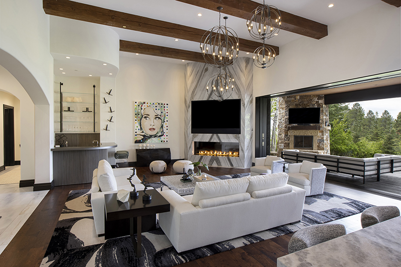 Living room featuring bold pop art, circular lighting fixtures, and seamless design adjacency with kitchen